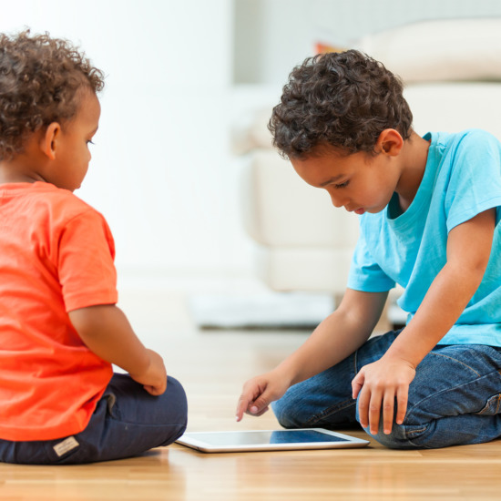 African american childrens using a tactile tablet